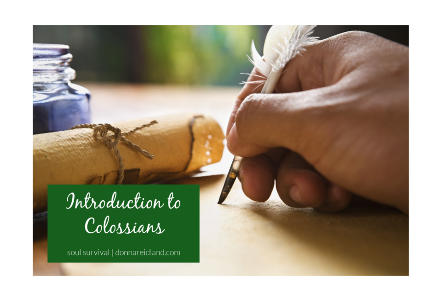 Hand writing with a quill pen on a scroll with text that reads, Introduction to Colossians