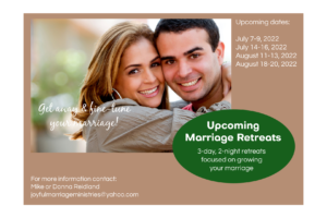 Happy couple with information about upcoming marriage retreats.