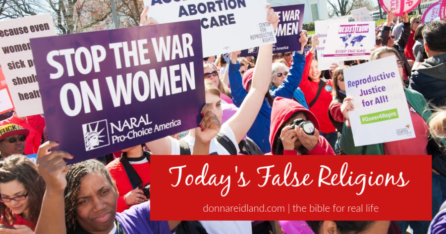 Protestors demanding the right to abortion with text that reads, Today's False Religions.