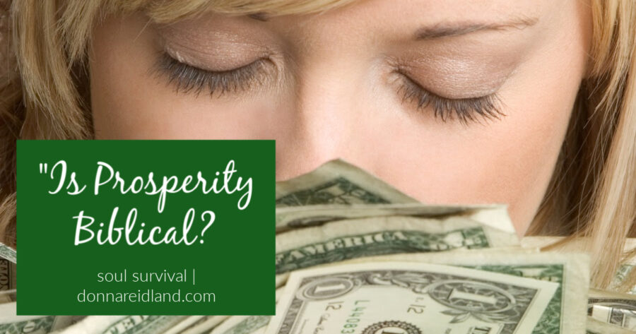Young woman kissing a handful of dollar bills with text that reads, Is Prosperity Biblical?