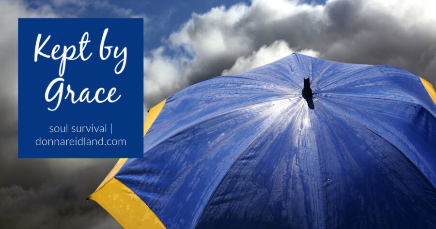 Big blue and yellow umbrella against a dark blue cloudy sky with text that reads, Kept by Grace