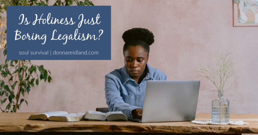 Young African-American woman sitting at a desk and studying her Bible with text that reads, Is Holiness Just Boring Legalism?