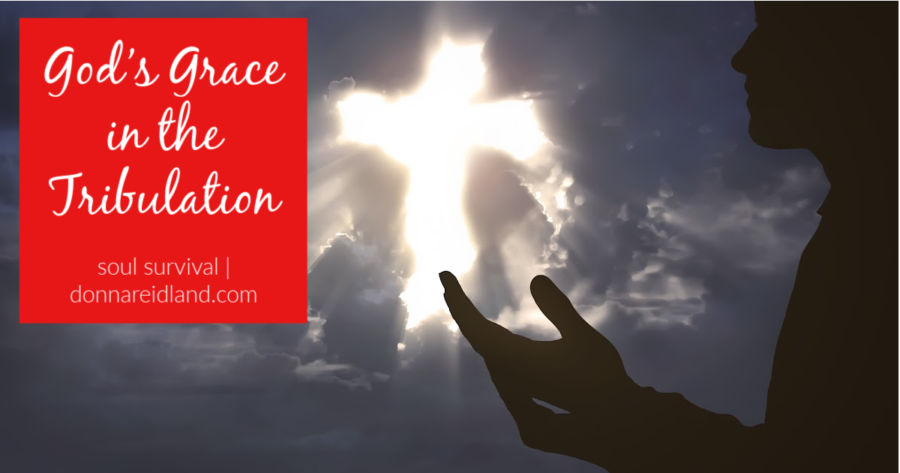 A glowing cross in the sky and the silhouetter of a man's hand lifted in prayer and praise with text that reads, God's Grace in the Tribulation.
