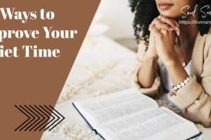 Beautiful African-American woman praying with an open Bible on the table in front of her with text that reads, 28 Ways to Improve Your Quiet Time