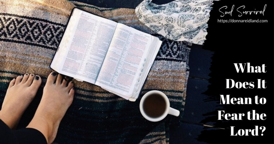 Woman's feet on a colorful blanket beside an open Bible and a cup of coffee with text that says, What Does It Mean to Fear the Lord?
