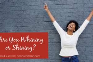 Joyful African American woman raising her arms with text that reads, are you whining or shining?