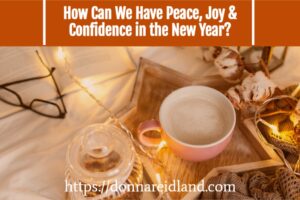 Cup of hot cocoa sitting on a table with Christmas lights with text that reads, How Can We Have Peace, Joy & Confidence in the New Year?