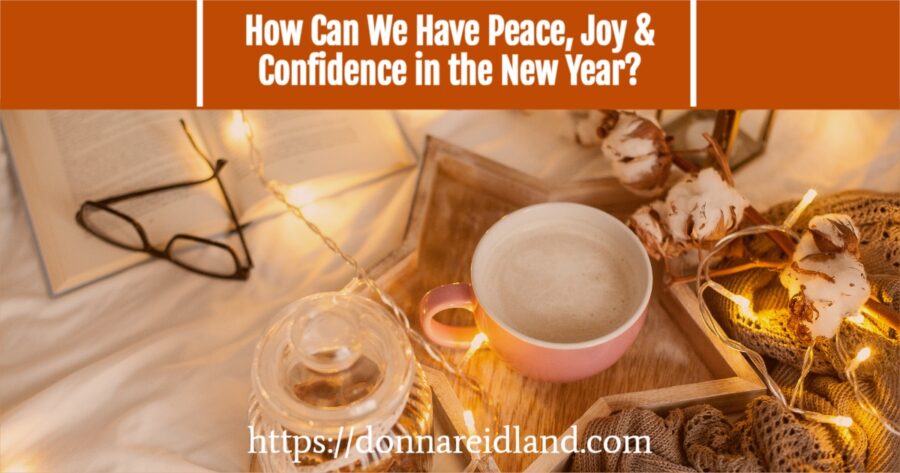 Cup of hot cocoa sitting on a table with Christmas lights with text that reads, How Can We Have Peace, Joy & Confidence in the New Year?