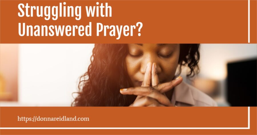 Woman praying earnestly with text that reads, Struggling with Unanswered Prayer?