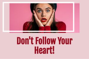 Shocked young woman in a red sweater with text that reads, Don't Follow Your Heart!