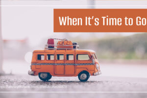 Toy camper van painted orange with luggage on top and text that reads, When It's Time to Go