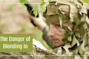 Man dress in camo blending in with his surroundings with text that reads, The Danger of Blending In