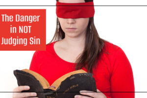 Woman attempting to read the Bible with a blindfold on with text that reads, The Danger in NOT Judging Sin