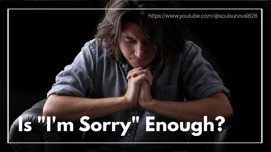 Man in a blue shirt with his head bowed in humble prayer