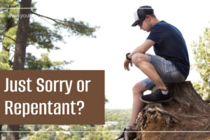 young man sitting on a boulder thinking regretfully