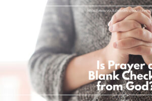 Woman in a gray sweater with her hands folded in prayer with text that reads: Is Prayer a Blank Check from God?